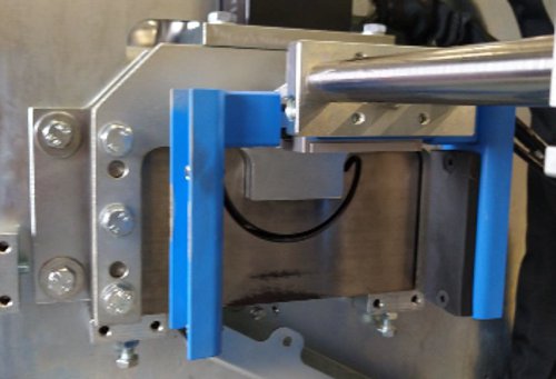 Hydraulic shear on an industrial half-round gutter machine